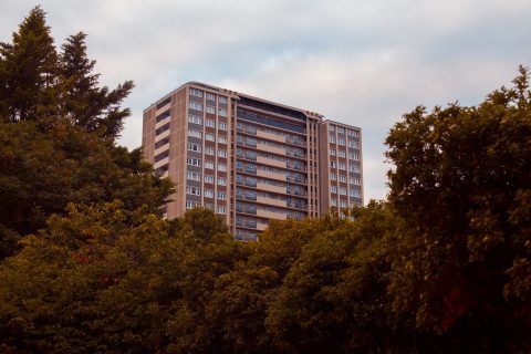 Edificio residencial en Madrid rodeado de árboles, ideal para ilustrar el cambio de vivienda en Madrid por el clima y opciones de barrio con Redpiso